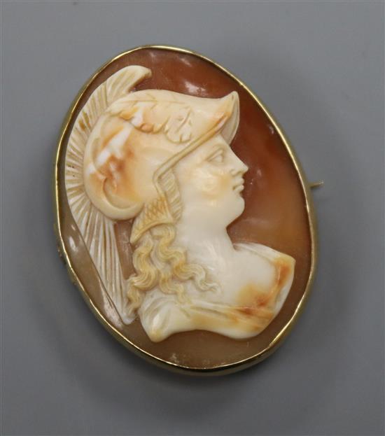 A yellow metal-mounted cameo brooch carved with the head of Minerva, 40mm.